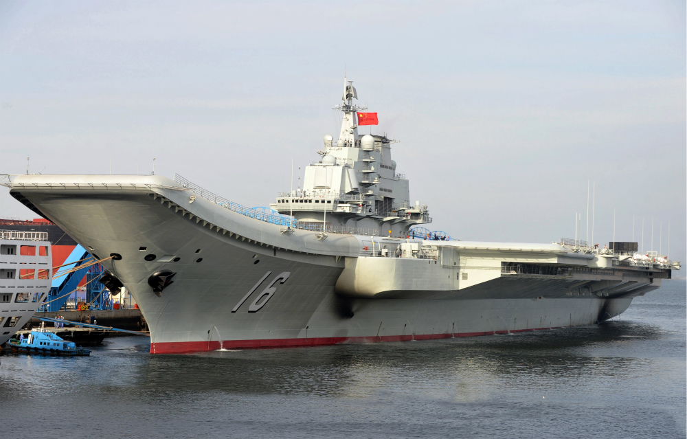 (120925) -- DALIAN, Sept. 25, 2012 (Xinhua) -- Undated photo shows an aircraft carrier berthing in a port of China. China's first aircraft carrier was delivered and commissioned to the Navy of the Chinese People's Liberation Army on Sept. 25, 2012. The carrier, with the name "Liaoning" and hull number 16, was officially handed over to the Navy at a ceremony held in a naval base of northeast China's Dalian Port. (Xinhua/Li Tang) (hdt)