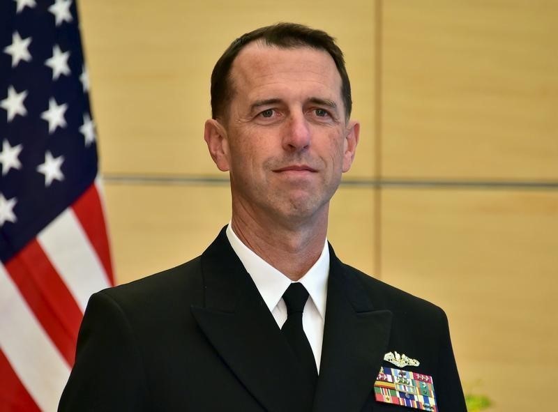 U.S. Navy Admiral John Richardson (L), the U.S. chief of naval operations, waits for Japan's Prime Minister Shinzo Abe before their talks at Abe's official residence in Tokyo October 15, 2015. U.S. naval vessels sailing through international waters in the South China Sea, including areas claimed by China, cannot be considered provocative, the U.S. Navy's most senior uniformed officer said on Thursday, while a Chinese newspaper called for a firm response to any "unscrupulous" U.S. behavior. REUTERS/Yoshikazu Tsuno/Pool - RTS4JHV